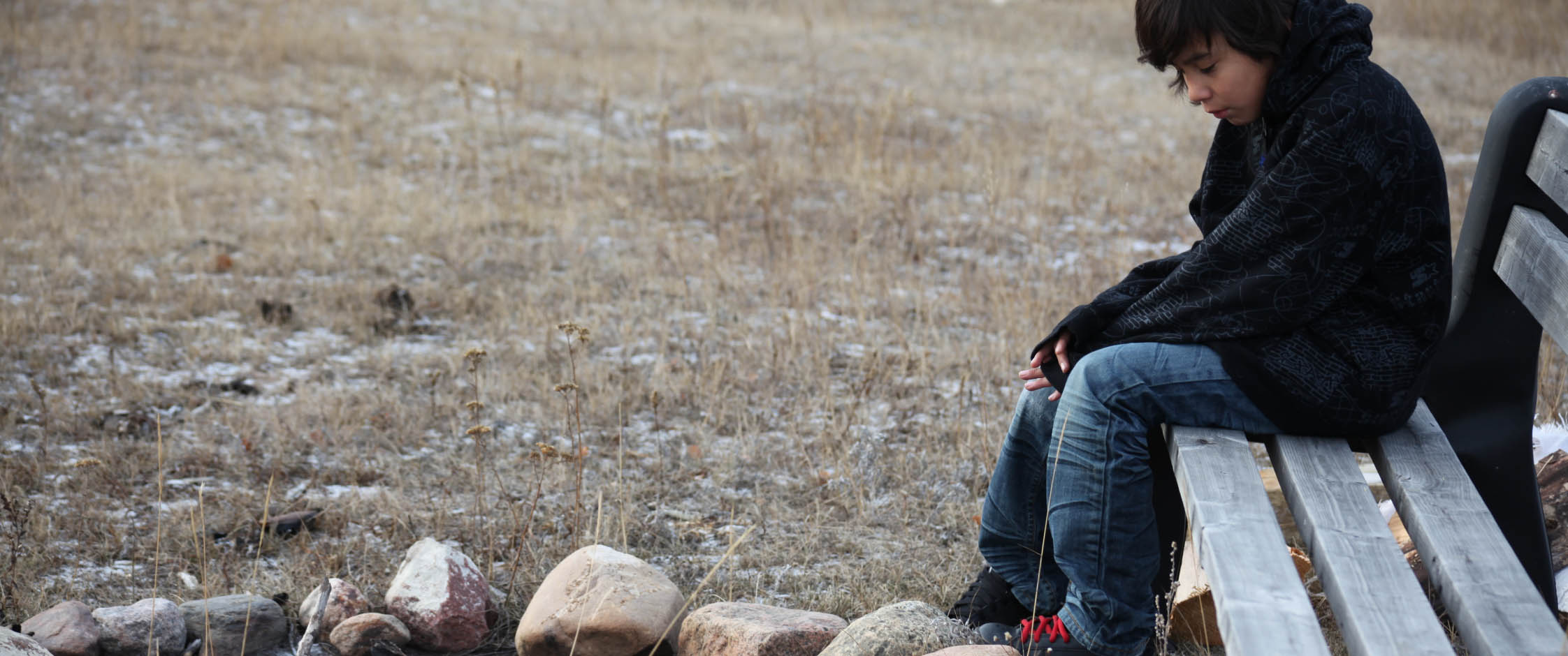 Male youth sitting on bench 