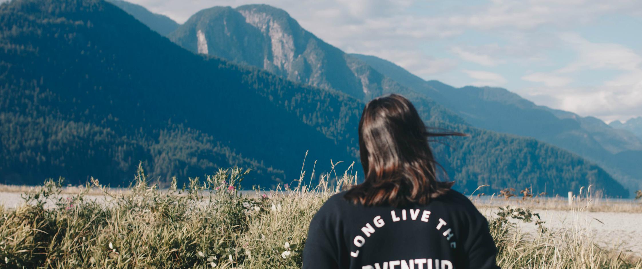 Young woman looking away at mountains.